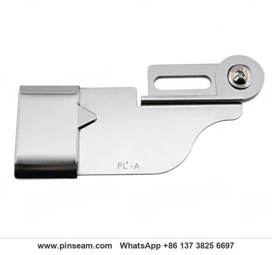 Close-up of a metal cuff binder attachment mounted on an industrial sewing machine Close-up of a metal cuff binder attachment mounted on an industrial sewing machine